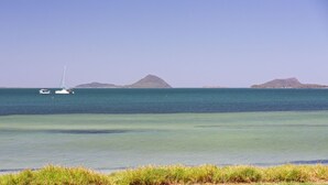 A coastal scene with two sailboats on calm waters, surrounded by small islands. - Pelican Sands 2 , 83 Soldiers Point Road - fantastic waterfront unit with pool and air conditioning (Soldiers Point)
