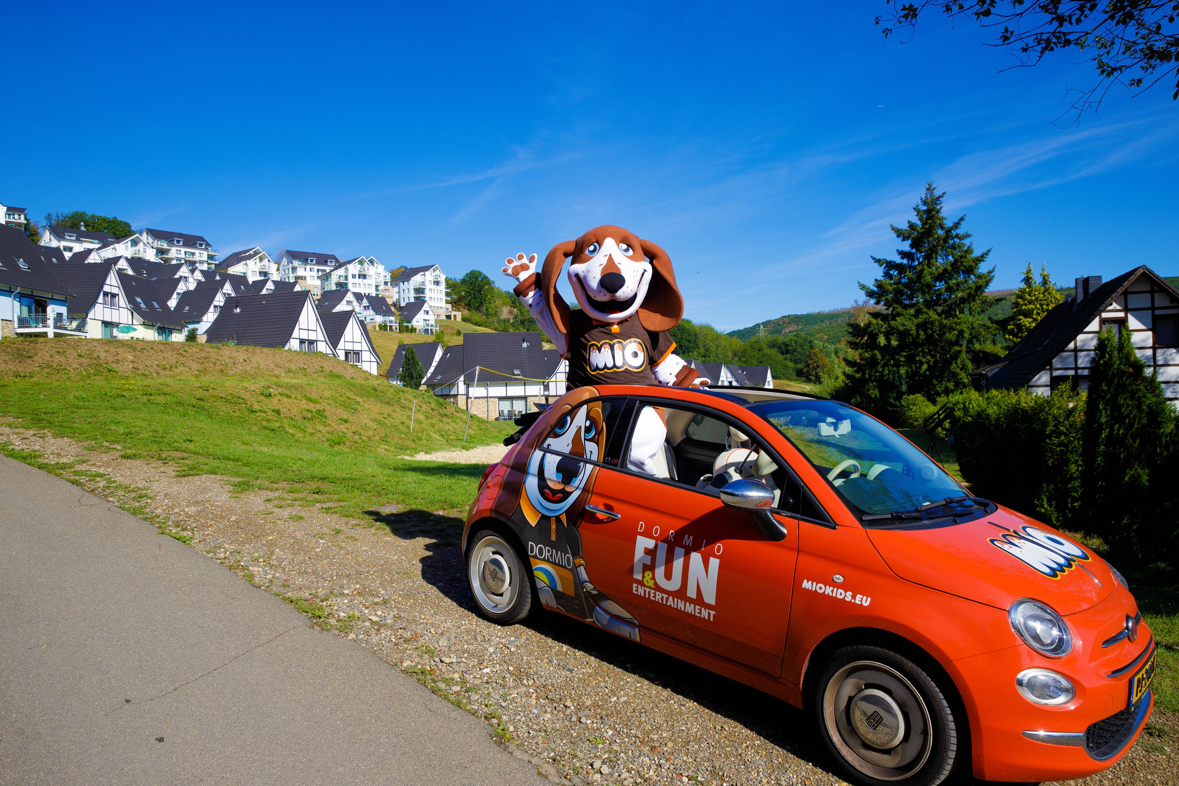 A car with a character on top and text indicating 'DORMIO FUN & ENTERTAINMENT'.