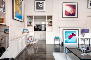 Comfort Apartment (1 Bedroom) | Living room | 35-inch TV with cable channels, books