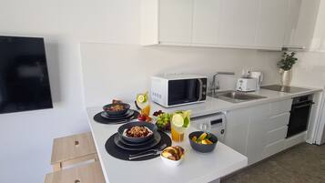 Luxury Studio | Private kitchen | Coffee/tea maker, dining tables