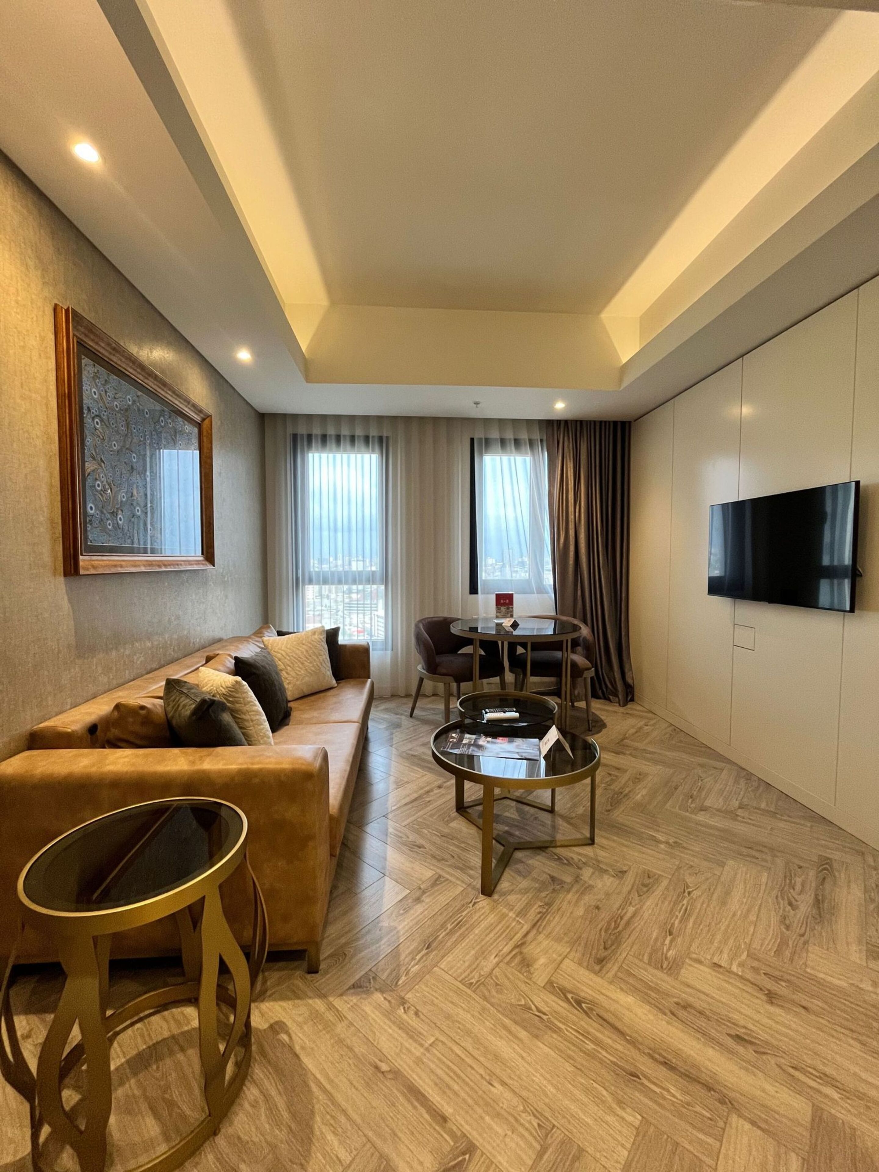 A modern living room with a sofa, coffee table, and TV.