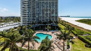 A high-rise hotel with a pool, palm trees, and a beach view. - Located in the desirable Marco Island community of South Seas (Marco Island)