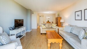 A living room with a TV, sofa, and coffee table. - Located in the desirable Marco Island community of South Seas (Marco Island)