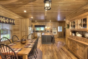 Enjoy cooking in this well-equipped kitchen with a central island, dining table, and ample storage.