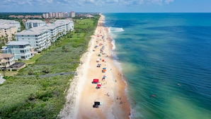 A coastal hotel with multiple buildings, a long beachfront, and a clear view of the ocean. - Renovated - 4th Floor Condo #143 with Golf & Ocean Views at Cinnamon Beach (Palm Coast)