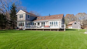 A two-story house with a large deck and a covered porch. - Costal Country Summer Home with Beach Access - 3 building compound (Westport)