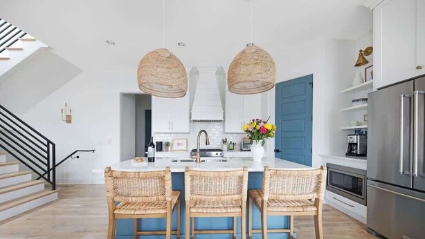 A modern kitchen with a central island, wicker chairs, and a stainless steel refrigerator. - The Jolene – Rooftop w/ Firepit, Close to 12 South (Nashville)