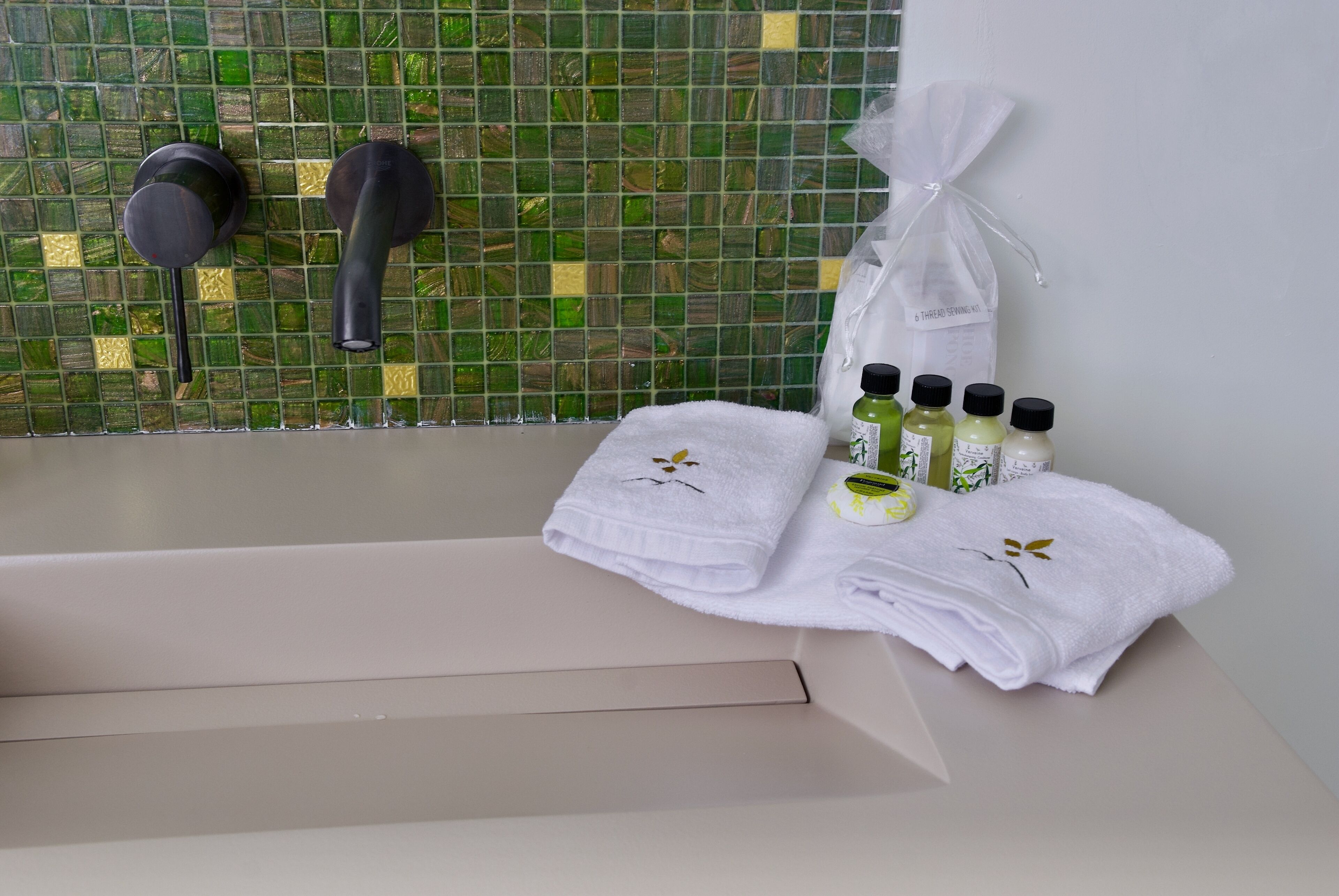 designer toiletries, hair dryer, bathrobes, slippers