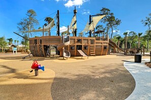 A playground with a pirate ship theme, including slides and climbing structures.