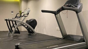 A gym with a treadmill, elliptical, and stationary bike. - 1 Bedroom apartment with views to green area and hamacs, Gym, Rooftop Pool (Playa del Carmen)
