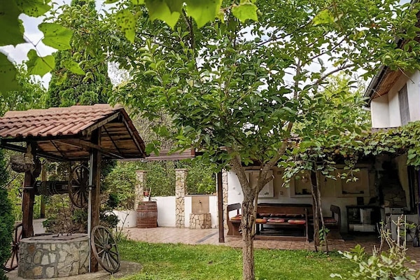Outside lawn and a dining area that sits eight