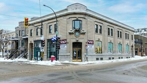 A historic building with a classic architectural style, featuring a prominent entrance and multiple windows. - St-Denis 209 · Amazing New Apartment Close to Mount Royal (Le Plateau) by Denstays (Montréal)