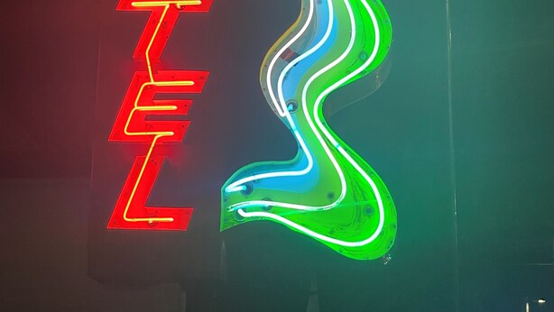 A neon sign for a motel with the name 'Sea Bay Motel' in green and red letters. - Searay Motel (Wildwood)