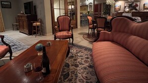 A spacious living room with a wooden coffee table, a sofa, and a dining area with chairs. - Farm house, 5 miles from Avignon! Vineyard (Jonquerettes)