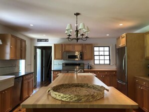 Enjoy cooking in this well-equipped kitchen with a central island and ample natural light.