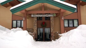 A building with a sign reading "Scandinavian Lodge" and a wreath above the entrance. - SL300 | Modern Penthouse | Views | Pool | Hot Tub | 100 Yds to Lift (Steamboat Springs)