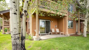A two-story house with a covered patio, a sliding glass door, and a small garden area.