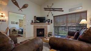 A cozy living room with a fireplace, a television, and a sign that reads "LET IT SNOW". - V1421 | Private Garage | Hot Tub | Free City Bus | 5 Minutes to Base Area (Steamboat Springs)