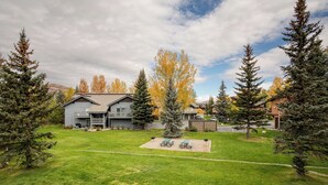 A two-story house with a front yard, a picnic table, and a small shed. - V1421 | Private Garage | Hot Tub | Free City Bus | 5 Minutes to Base Area (Steamboat Springs)