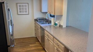 Condo, 2 Bedrooms | Private kitchen - Caper Beach Club 412 by Coastal Vacation Properties (Fort Myers Beach)