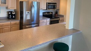 Condo, 2 Bedrooms | Private kitchen - Caper Beach Club 412 by Coastal Vacation Properties (Fort Myers Beach)