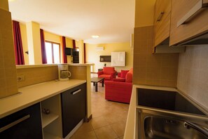 A compact kitchen with a built-in oven, a coffee maker, and a sink. - "Villa Imelda" spacious, bright apartments, garden or patio, lake view (Limone Sul Garda)