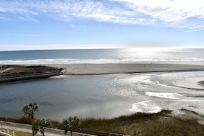 A beach with a calm water body, a sandy shore, and a clear sky. - Southern View- All New! Modern & Stylish-Your Paradise Awaits! + Locker! (Myrtle Beach)