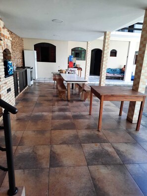 Enjoy meals and gatherings in this outdoor dining area with a long table and comfortable benches.