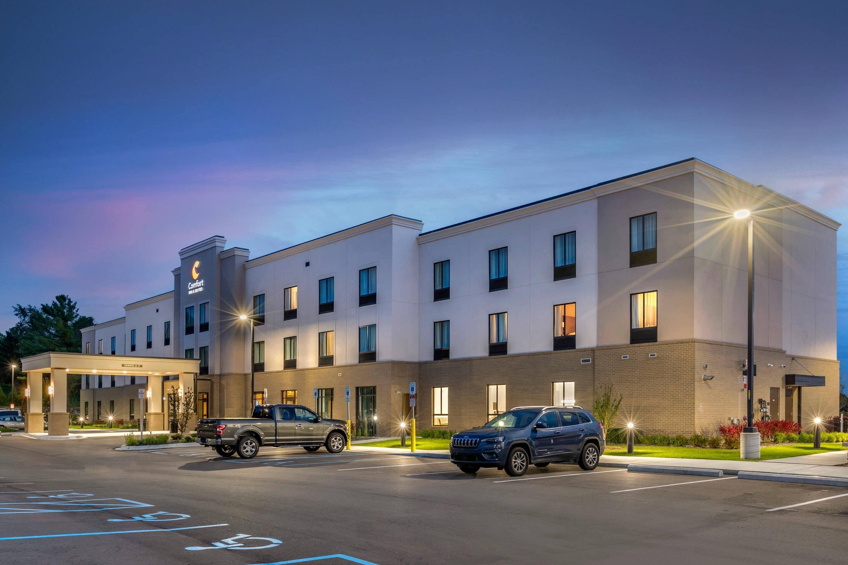 A hotel with a modern design, multiple floors, and a covered entrance.