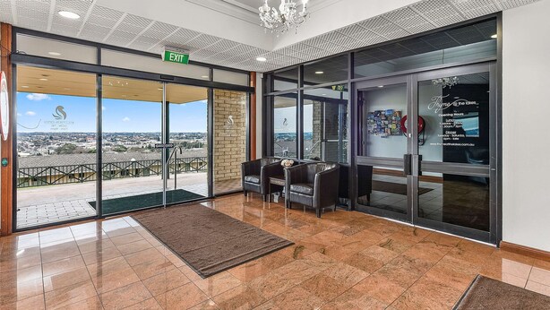 A hotel lobby with a view of the city, a chandelier, and a reception desk. - Comfort Inn The Lakes (Mount Gambier)