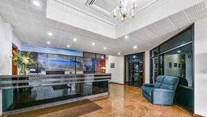 A hotel lobby with a reception desk, a large window, and a blue mural on the wall. - Comfort Inn The Lakes (Mount Gambier)