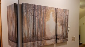A room with a large painting of a forest scene on the wall. - Wooded, peaceful setting 15 minutes from  the Lake! (Sandpoint)