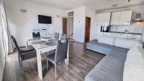 A modern apartment with a dining area, a living room, and a kitchen. - Apartment Maya 1 (Marušici)