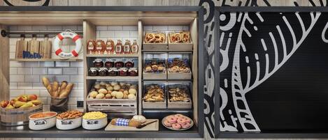 A bakery display with various baked goods and pastries.