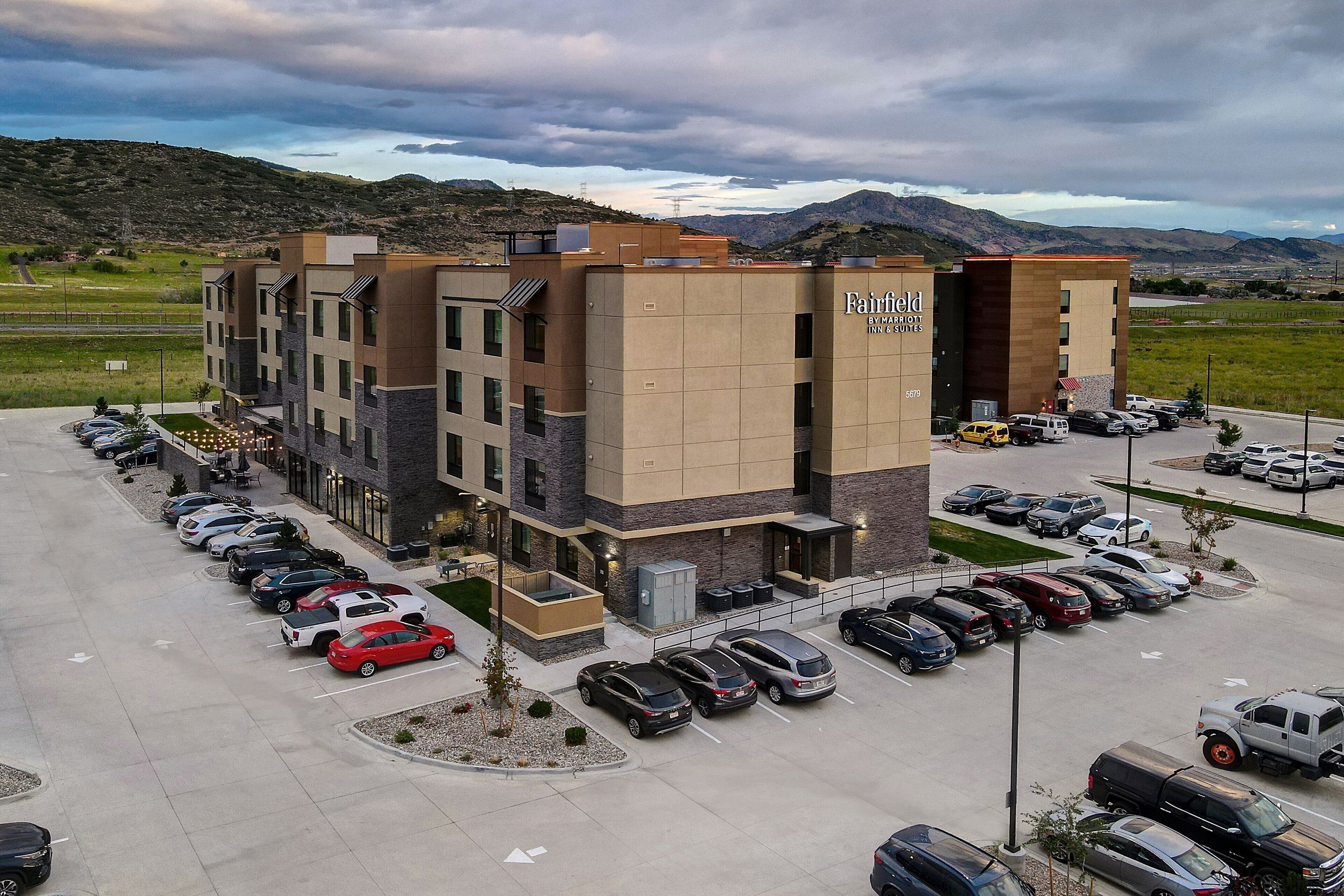 A multi-story hotel with a parking lot.