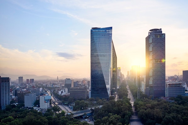 A cityscape with two prominent skyscrapers, one with a unique twisted design and the other with a more traditional rectangular shape.