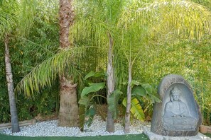 Escape to a serene oasis surrounded by lush tropical plants and a tranquil atmosphere.