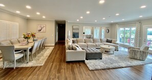 A spacious living room with a dining area, a sectional sofa, and a coffee table.
