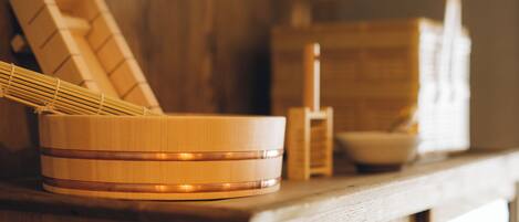 A wooden table with a woven basket and a wooden container.