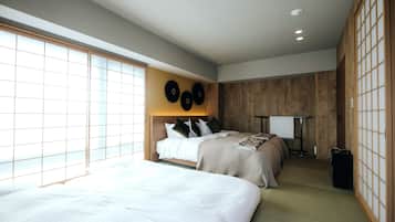 A hotel room with two beds, a large window, wooden paneling, and a traditional Japanese-style wall with tatami mats.