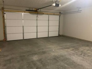 A garage with a concrete floor and a closed garage door. - 704 diamond loop new listing (Middletown)