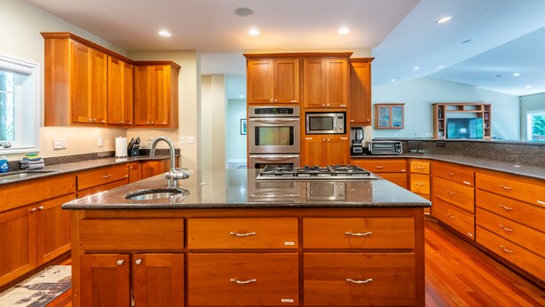 A modern kitchen with wooden cabinets, stainless steel appliances, and a large island. - Spectacular Golf Group Vacation Rental at Bandon Dunes Golf Resort (Bandon)
