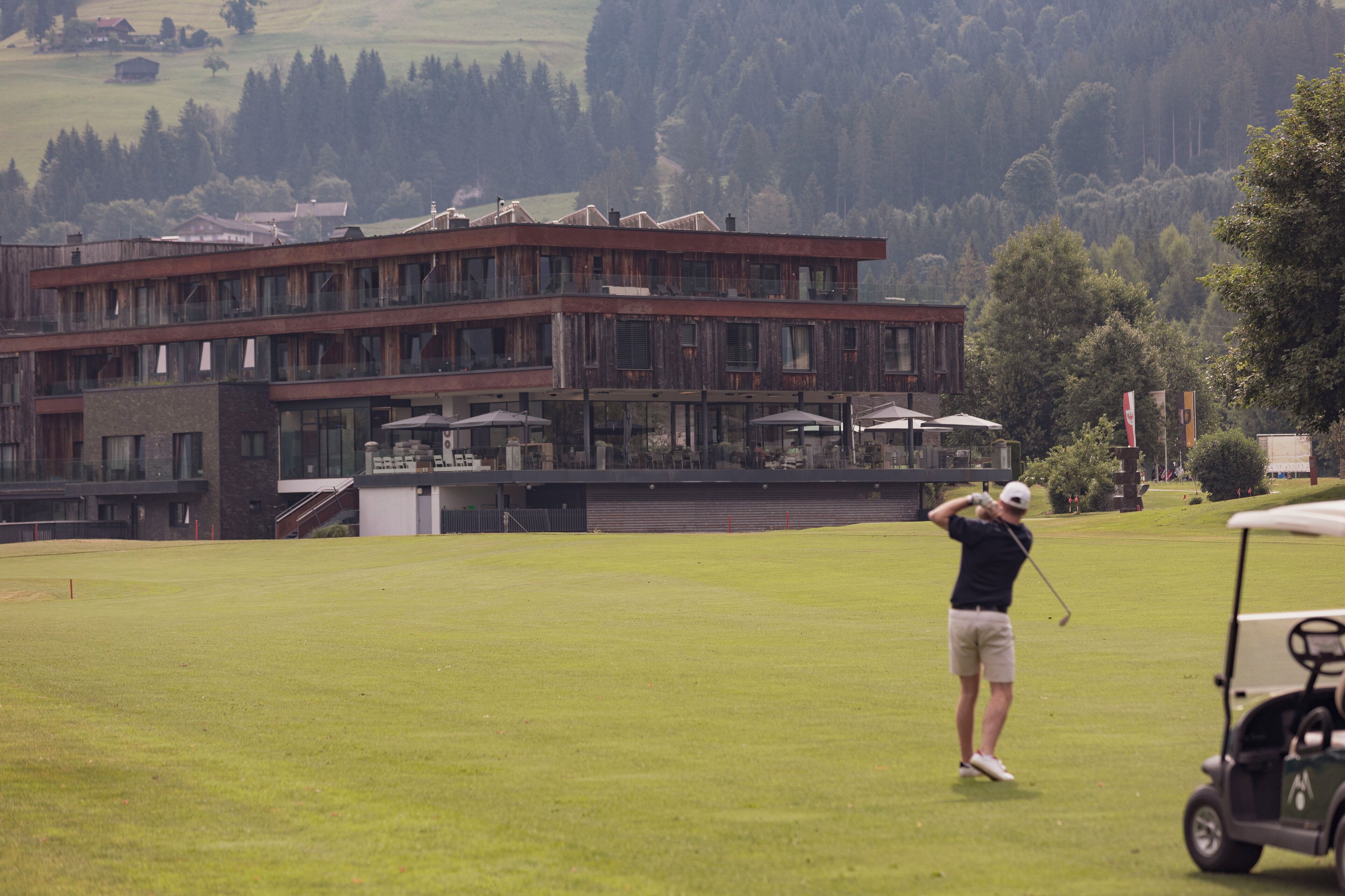 A golf course with a building in the background.