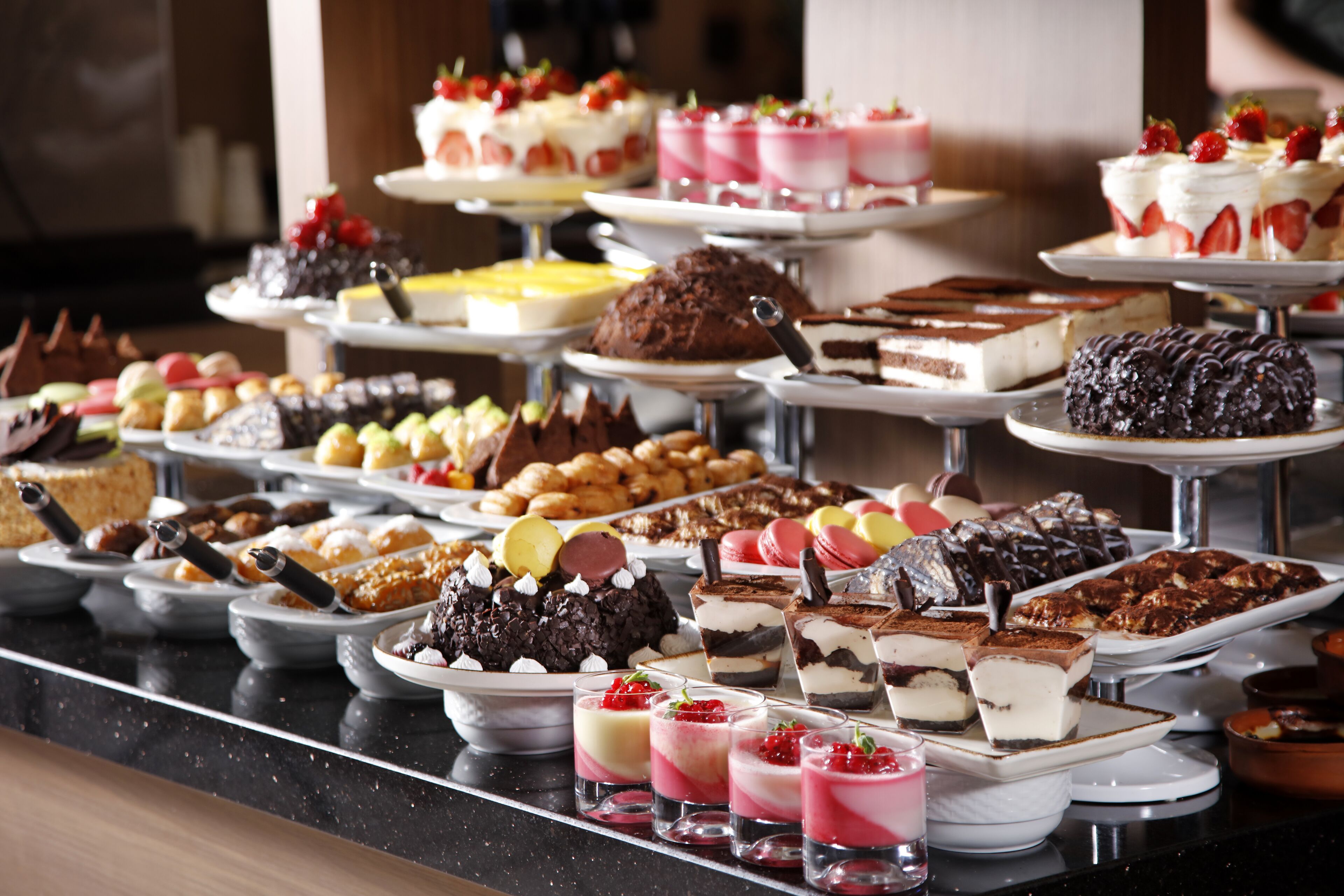 A buffet with various desserts and pastries.