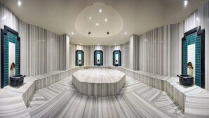A modern bathroom with a central marble sink, striped walls, and recessed lighting. - Allia Thermal Health & Spa Kazdagları (Edremit)