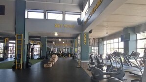 A gym with cardio equipment, weight machines, and a spinning area. - The Blyde 1317 (Pretoria)