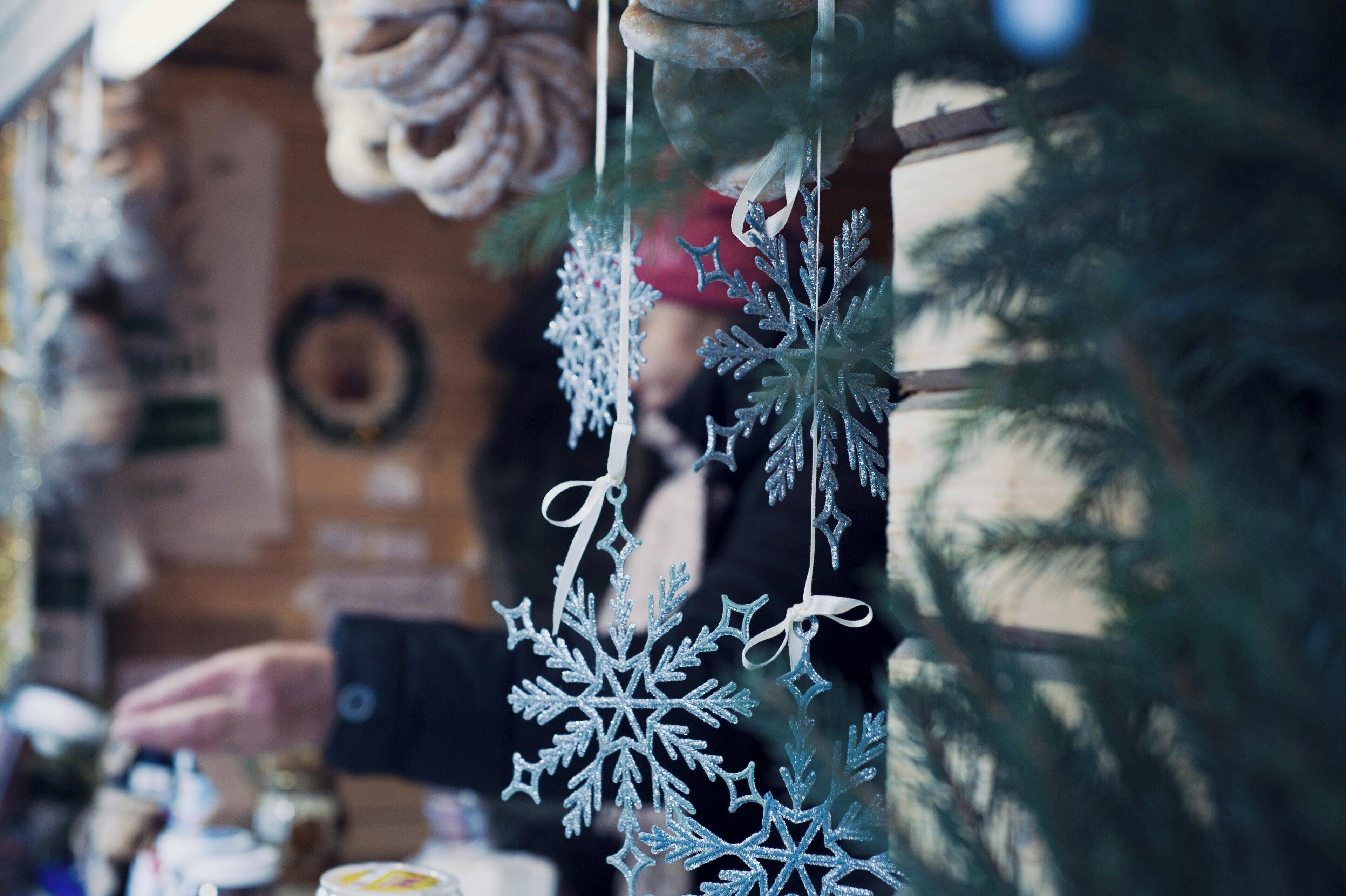 A close-up of a Christmas ornament hanging from a tree.