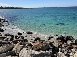 Enjoy the serene coastal scenery with a clear view of the sandy ocean floor.