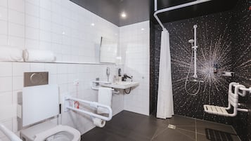 A modern bathroom with a toilet, sink, and shower.