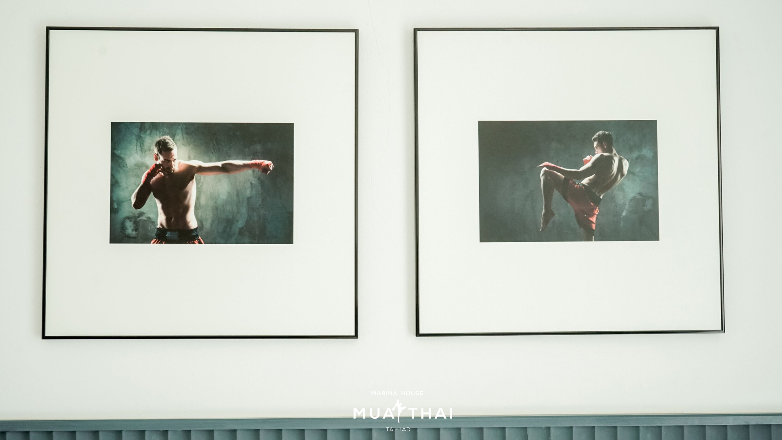 Two framed pictures of a martial artist in dynamic poses on a wall.